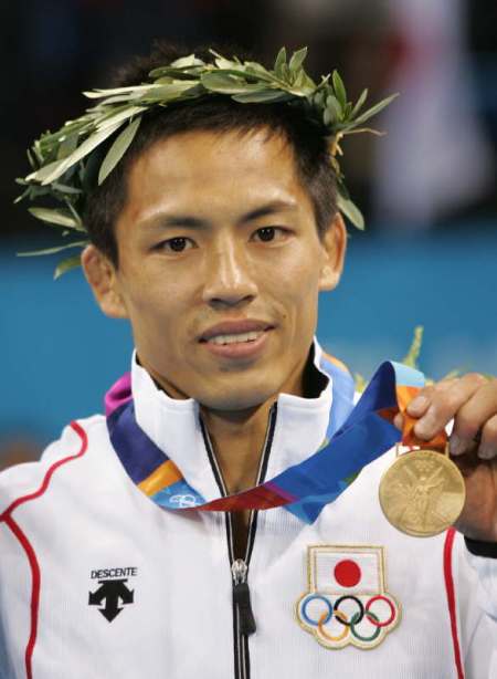 Japan's Nomura celebrates displays gold medal in judo men's extra lightweight at the Athens 2004 ...